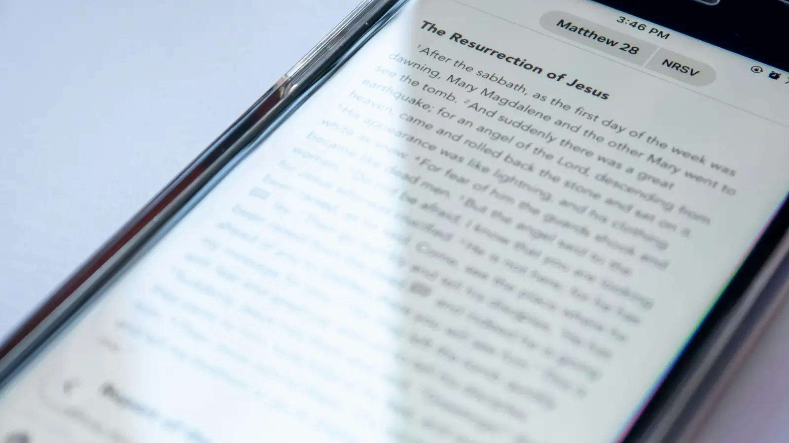 Close-up of a phone screen showing a chapter of the Gospel of Matthew in a Bible reading app.
